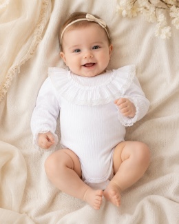 Eleganckie prążkowane białe body dla dziewczynki z koronkową falbanką